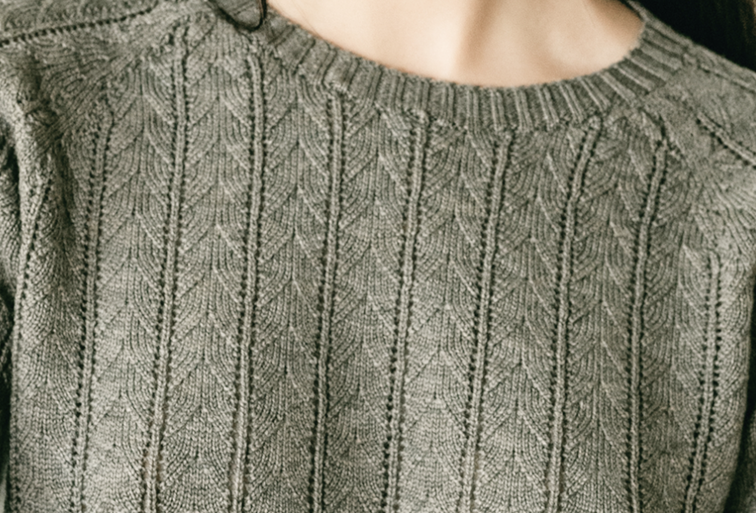 Engineered cable and pointelle stitch on a sage knit crewneck